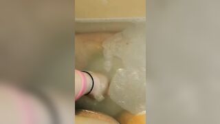 Glass dildo in bathtub