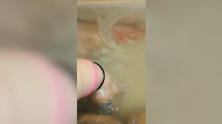 Glass dildo in bathtub