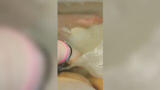 Glass dildo in bathtub