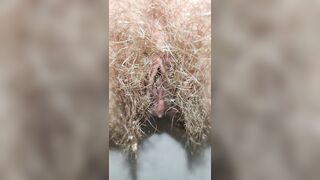 Hairy milf peeing in the toilet